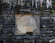 The Old Dairy Barn stone sign in a stone wall, Cotswolds, England
