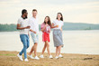 © Seventyfour - Multiethnic teenagers walking on the beach and discussing beautiful nature