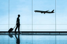 Silhouette Of Woman In Airport Traveling With Luggage Suitcase, Travel And Tourism Concept, Airplane Tickets