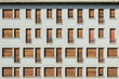 Concrete facade with series of facade of windows and small balconiesConcrete facade with series of facade of windows and small balconies