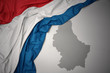 waving colorful national flag and map of luxembourg .