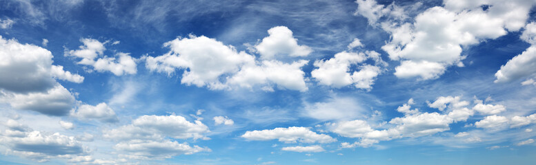 white fluffy clouds on blue sky in summer on sunny day