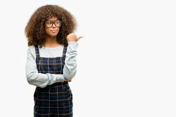 Sticker - African american woman wearing a retro style pointing with hand and finger up with happy face smiling