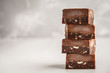 Stack of chocolate fudge bars on white background. Raw vegan dessrt.