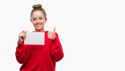 Poster - Young blonde woman holding advertising banner happy with big smile doing ok sign, thumb up with fingers, excellent sign