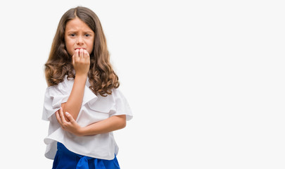 Wall Mural - Brunette hispanic girl looking stressed and nervous with hands on mouth biting nails. Anxiety problem.