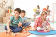 © New Africa - Cute little children playing with wooden blocks indoors