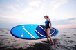© Evgeniy Kalinovskiy - attractive young girl with sup board on the background of the sea and sunset