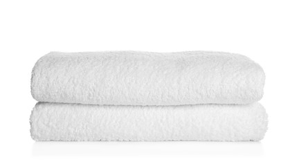 Stack of clean soft towels on white background