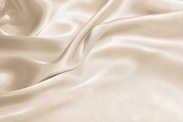 Wall Mural - The texture of the satin fabric of beige color for the background 