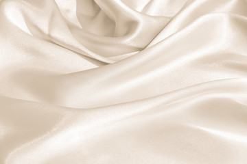 Wall Mural - The texture of the satin fabric of beige color for the background 