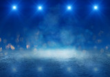 Fototapeta Sport - Empty scene of a show with lanterns and concrete floor, blue abstract background with bokeh, lights, rays
