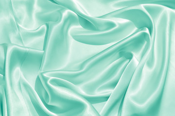 Wall Mural - The texture of the satin fabric of green color for the background 