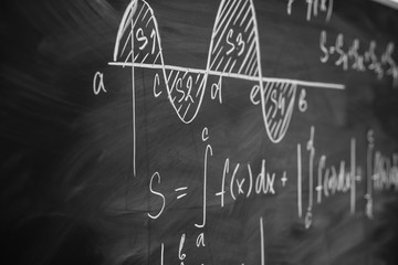Wall Mural - Mathematics function integra graph formulas on the chalkboard.