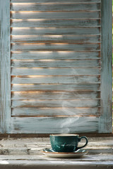 Wall Mural - Cup of hot coffee and open book on old windowsill