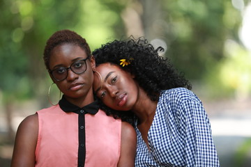 Ethnic lesbian couple in park