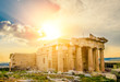 Glowing sun rays illuminate ancient Erechtheum temple ruins, Acropolis, Athens, Greece