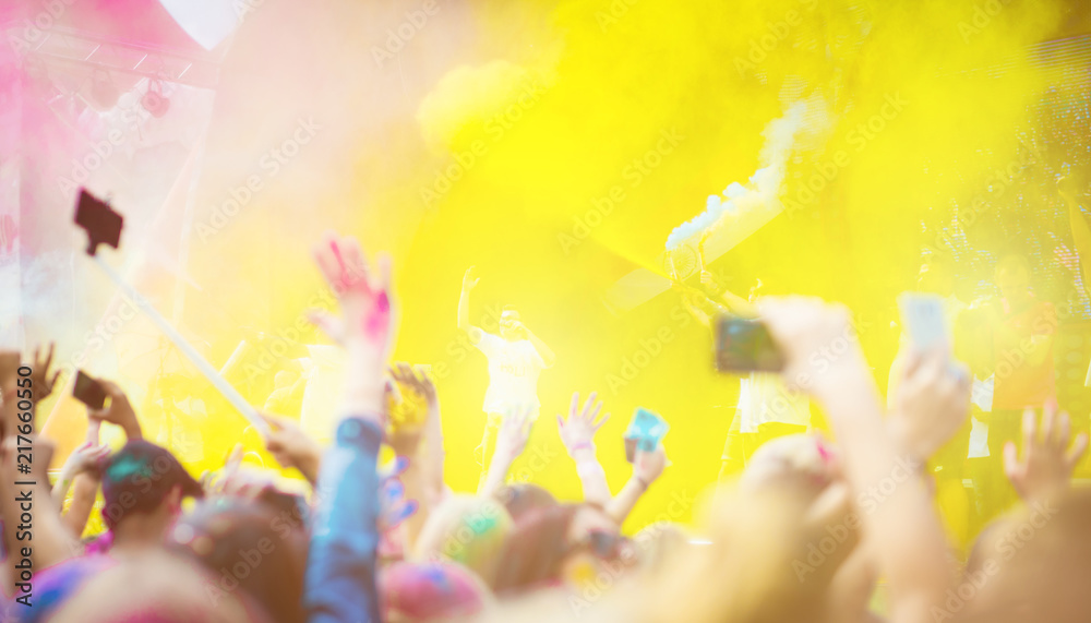 Crowd of people dancing and celebrating Holi festival of colors. People ...