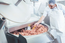 Butcher Checking Minced Meat For The Right Quality And Consistency