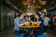 © Danon - Portrait of a good looking Chinese Asian couple enjoying a snack at a hawker center during the weekend. They are smiling as they talk and enjoy sugarcane juice and fried bananas.