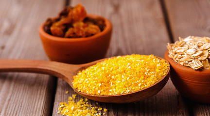 a bowl of corn is on a wooden table