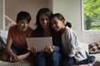 © Wavebreak Media - Mother and kids having video call on laptop in living room