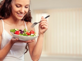 Wall Mural - Attractive caucasian smiling woman with salad