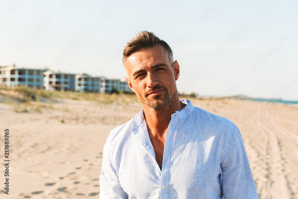 Portrait of a handsome man in shirt standing - obrazy, fototapety, plakaty 