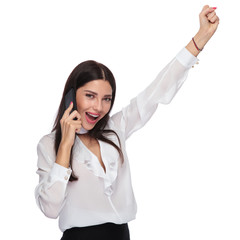 Wall Mural - portrait of beautiful businesswoman talking on the phone and celebrating