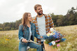 © LIGHTFIELD STUDIOS - smiling young lovers with retro bicycle in field with wild flowers