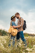 © LIGHTFIELD STUDIOS - tender couple in love with backpacks in summer field with wild flowers