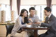 © Blue Jean Images - Happy young couple buying new house from realtor