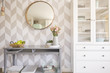 © Photographee.eu - Mirror on patterned wallpaper above grey table with flowers in s