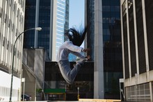 Female Street Dancer Dancing In City