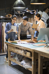 Confident leather craftspeople working in studio