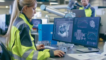 Poster - At the Factory: Female Mechanical Engineer Designs 3D Engine on Her Personal Computer, Male Automation Engineer Uses Laptop for Programming Robotic Arm. Shot on RED EPIC-W 8K Helium Cinema Camera.