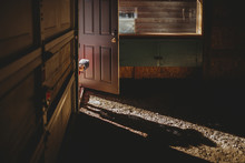 Portrait Of Baby Boy Peeking Through Doorway In Abandoned House
