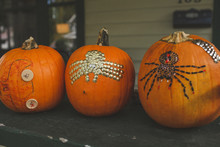 Close-up Of Decorated Pumpkins On Wooden Table At Home During Halloween