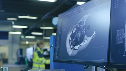 Poster - Close-up Shot of the 3D CAD Model of the Engine Shown on Computer Screen. In the Background Manufacturing Factory with People Working. Shot on RED EPIC-W 8K Helium Cinema Camera.