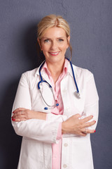 Wall Mural - Smiling female doctor portrait. Studio shot