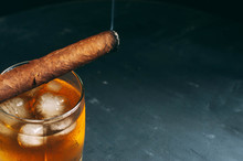 Quality Cigars And Cognac On Dark Dining Accessories, Cigar Scissors And Lighter.