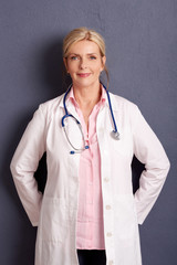 Wall Mural - Smiling female doctor portrait. Studio shot