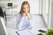 © gzorgz - Businesswoman looking thoughtfully while sitting at office desk