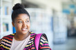 © pressmaster - Smiling attractive African-American overweight student with hair bun reflecting about future and looking aside while thinking about university entry