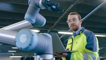 Fototapete - Close-up Shot of the Industrial Engineer Wearing Classes and Hard Hat Connects Two Components He Designed. Precision in Mechanical Engineering.