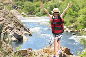 Wall Mural - little girl on rock near river. summer camp