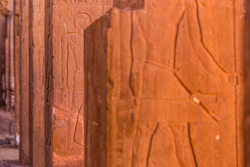 Wall Mural - stone wall with Egyptian carving figures and hieroglyphs, Aswan, Egypt, Africa.