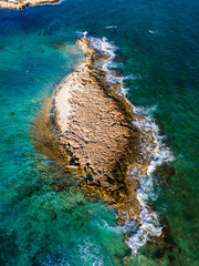 Sticker - A tiny stony island close to the shore of Ayia Thekla chapel, just outside of the cosmopolitan Ayia Napa.  The warm turquoise water is magnificent!