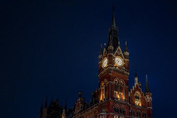 Wall Mural - English landmarks and railroad stations concept with the clock tower at St Pancras international train station in London,UK at night against the dark blue sky with copy space