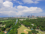 Fototapeta Miasta - Aerial view Downtown from Barton Creek in Greenbelt at Zilker Metropolitan Park south Austin with summer blue cloud sky. Located at eastern edge of Hill Country, Austin the state capital of Texas, US.